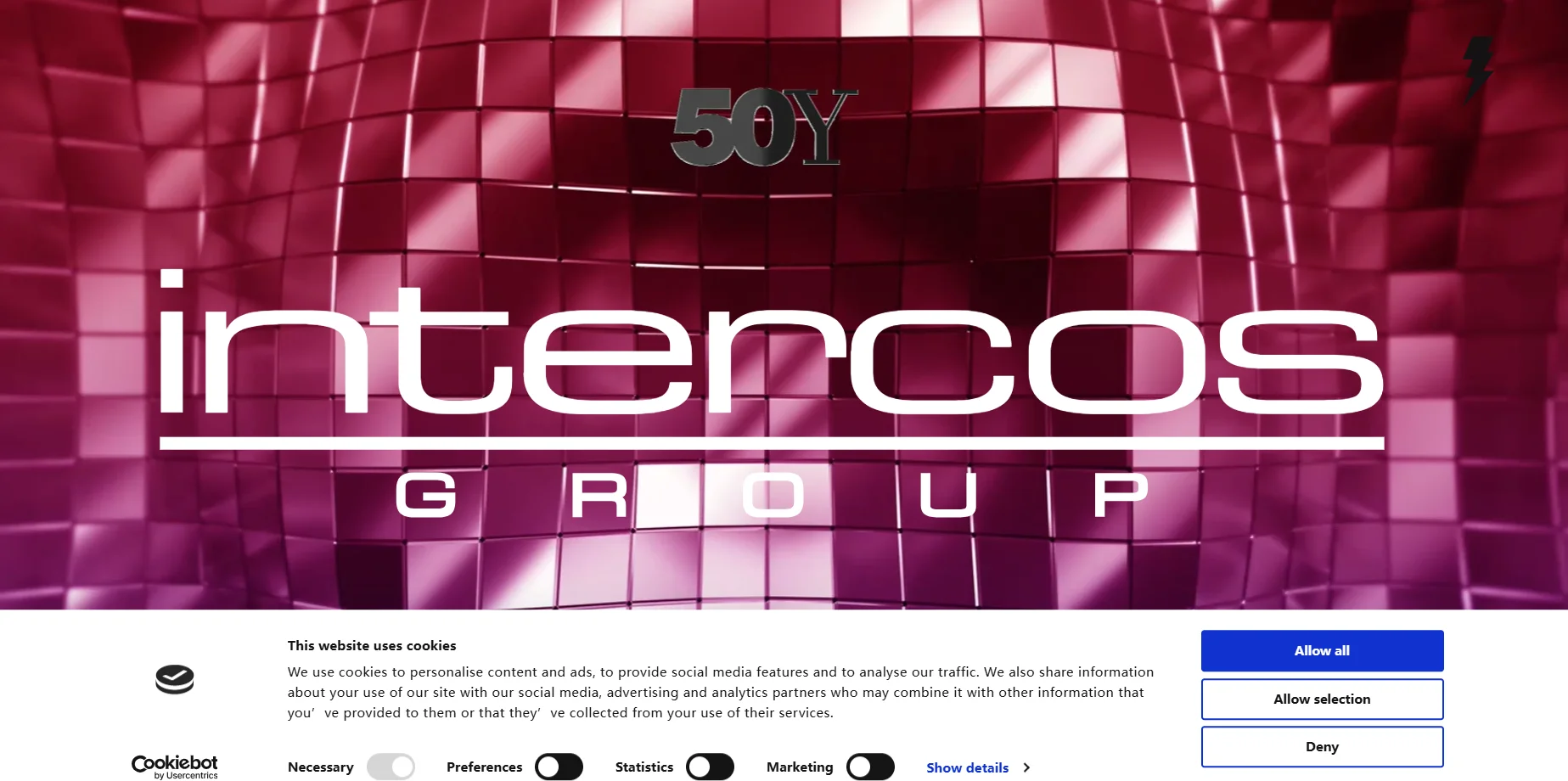 Intercos Group logo with 50Y symbol on a pink tiled background, emphasizing 50th anniversary.
